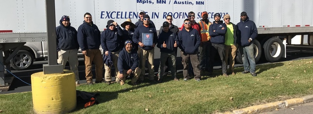 Text: Group photo of the Allweather Roof crew, showcasing their professionalism and teamwork in delivering exceptional roofing services.