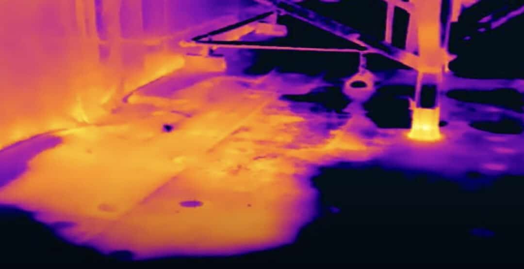 Aerial thermal image of a commercial roof, highlighting heat signatures for energy assessment and optimization.