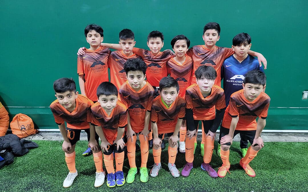 Group photo of a boys' soccer team wearing Allweather Roof branded uniforms, demonstrating the company's support for youth sports.